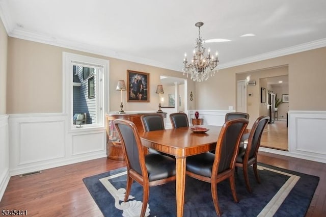 25 Hook Mountain Dr, Clinton Twp, NJ 08801 - dining room featuring a notable chandelier, wainscoting, wood finished floors, visible vents, and ornamental molding