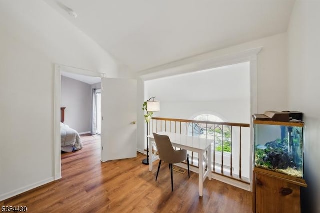 sitting room featuring vaulted ceiling and wood finished floors