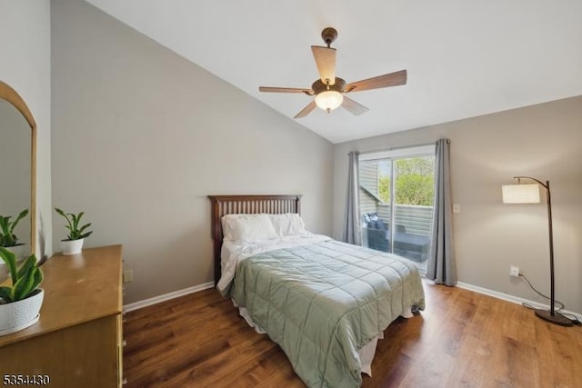 bedroom featuring baseboards, access to exterior, wood finished floors, and lofted ceiling