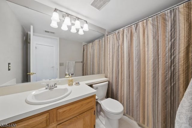 bathroom featuring visible vents, toilet, and vanity