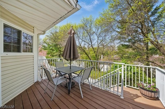 wooden terrace featuring outdoor dining area