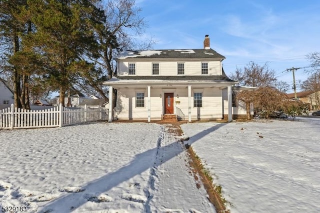 view of front of home featuring fence, a chimney, and a porch