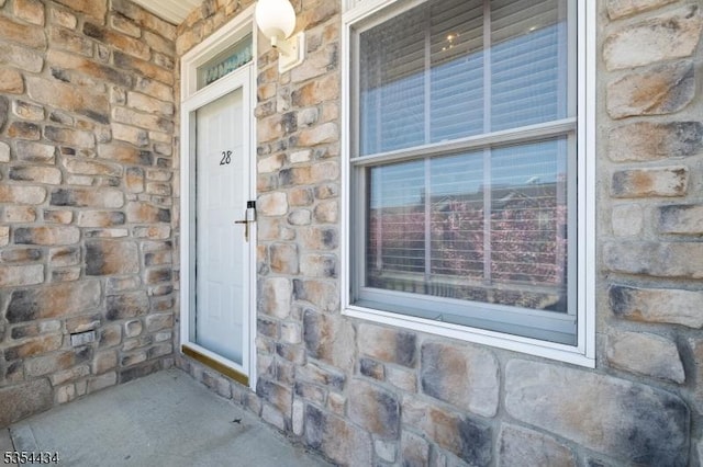 entrance to property with stone siding