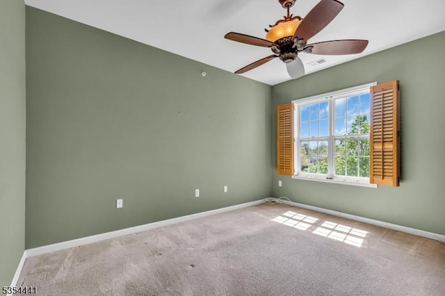 unfurnished room featuring carpet floors, baseboards, and ceiling fan