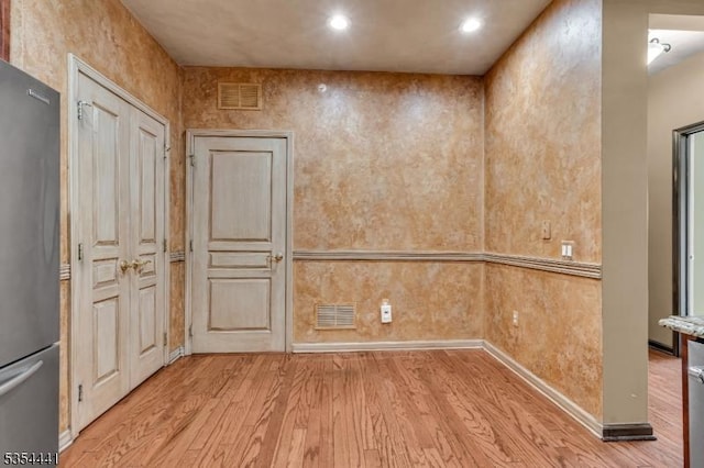 unfurnished room with light wood-style flooring and recessed lighting