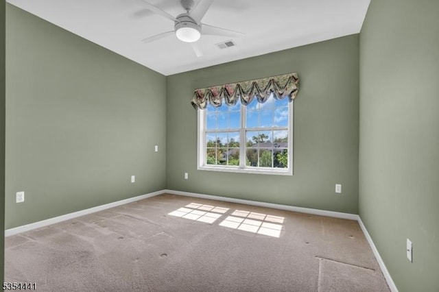 empty room featuring carpet floors, ceiling fan, and baseboards