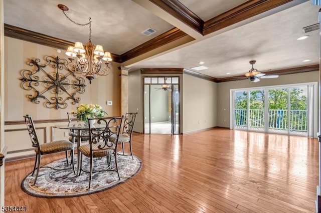 dining space featuring ceiling fan, ornamental molding, a chandelier, wood finished floors, and baseboards