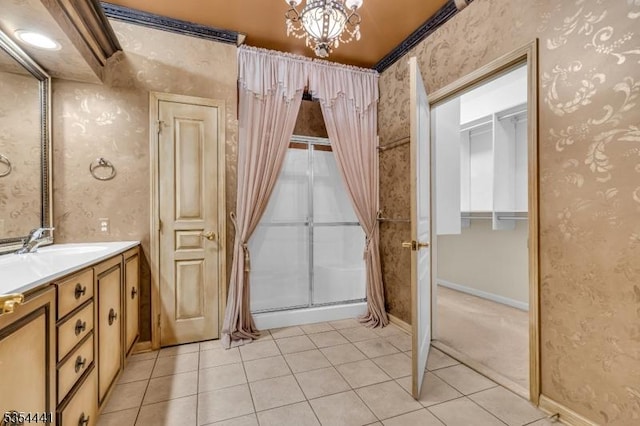 bathroom with tile patterned flooring, vanity, a shower with shower curtain, a chandelier, and wallpapered walls