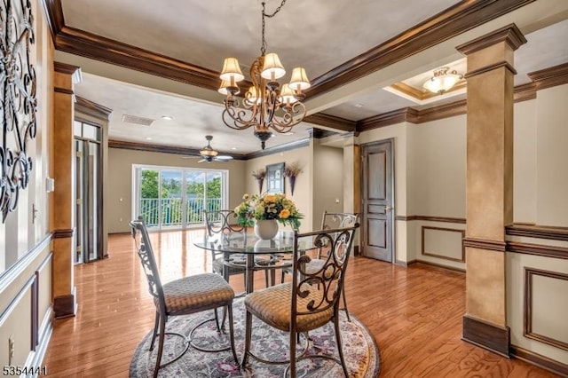 dining space featuring ornamental molding, a chandelier, light wood finished floors, ceiling fan, and decorative columns