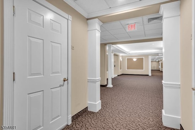 corridor with carpet, baseboards, and a paneled ceiling