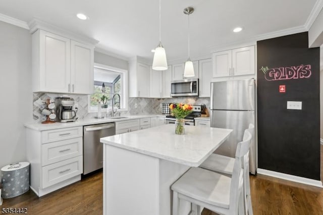 kitchen featuring crown molding, white cabinetry, dark wood finished floors, and stainless steel appliances