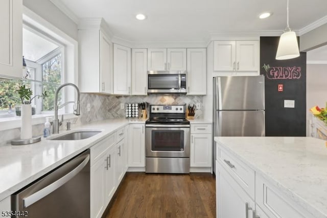kitchen featuring stainless steel appliances, recessed lighting, white cabinetry, and a sink