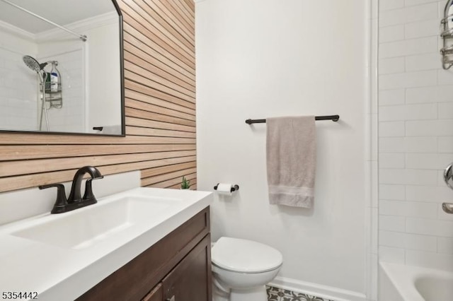 bathroom featuring vanity, ornamental molding, toilet, baseboards, and washtub / shower combination