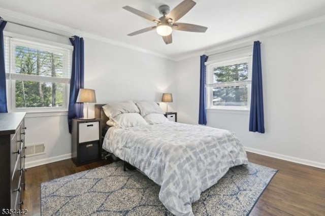 bedroom featuring baseboards, visible vents, ornamental molding, and wood finished floors