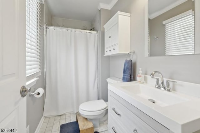 bathroom with crown molding, vanity, toilet, and curtained shower