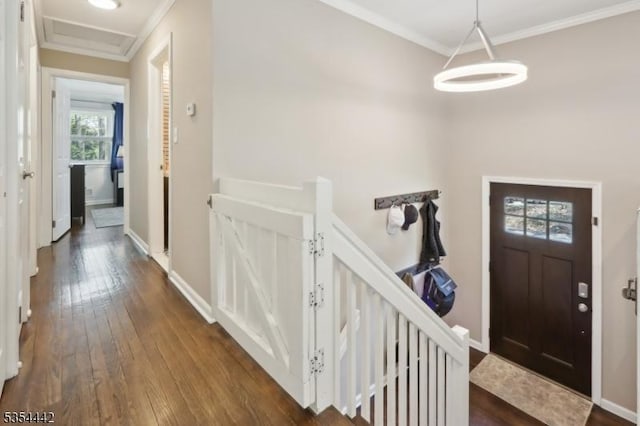 entrance foyer featuring crown molding, baseboards, and dark wood finished floors
