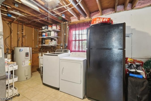 clothes washing area featuring laundry area, water heater, and washing machine and clothes dryer