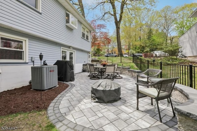 view of patio / terrace with fence, outdoor dining area, and cooling unit