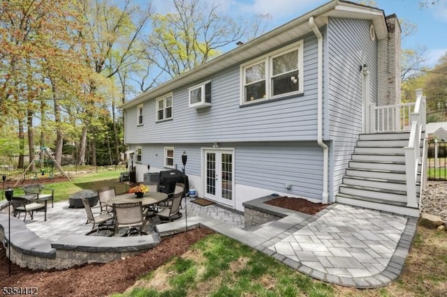 rear view of house featuring a patio, french doors, and a chimney