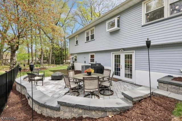 view of patio / terrace featuring fence, an outdoor fire pit, grilling area, cooling unit, and french doors