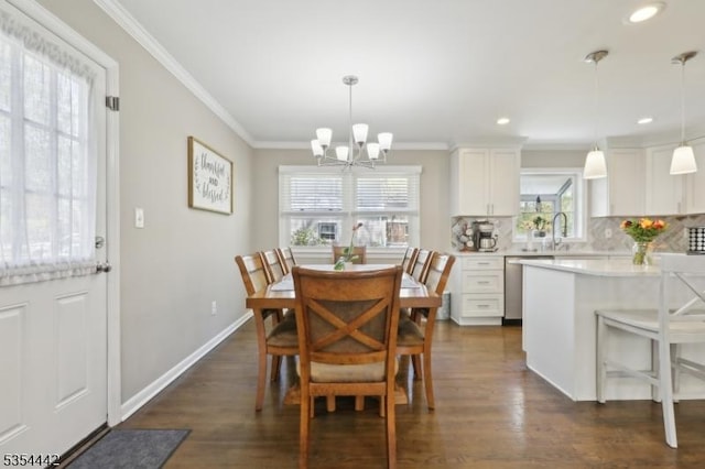 dining area with an inviting chandelier, ornamental molding, dark wood-type flooring, and recessed lighting