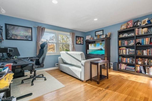 office space featuring wood finished floors, recessed lighting, and baseboards