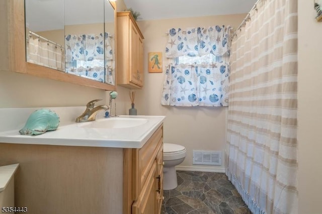 full bathroom with vanity and toilet