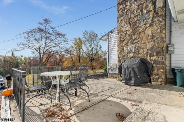 view of patio / terrace featuring outdoor dining space and a grill