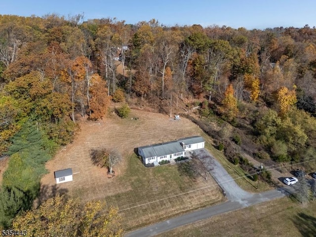 aerial overview of property's location featuring a heavily wooded area
