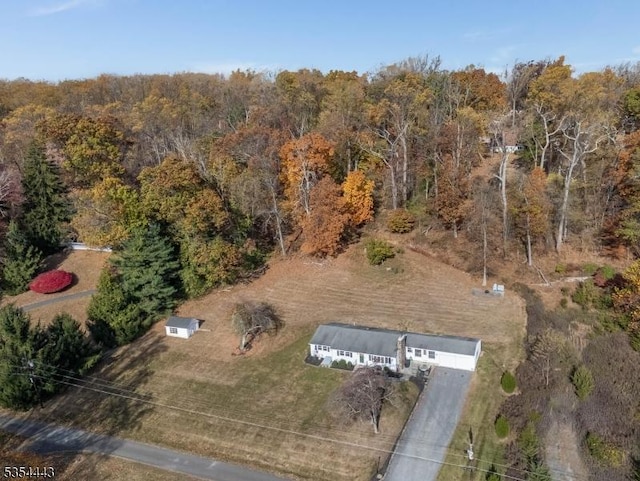 aerial view of property's location featuring a heavily wooded area