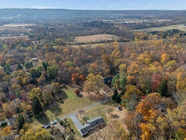 aerial view of property's location featuring a forest