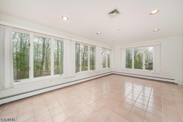 unfurnished sunroom featuring a baseboard heating unit, visible vents, and baseboard heating