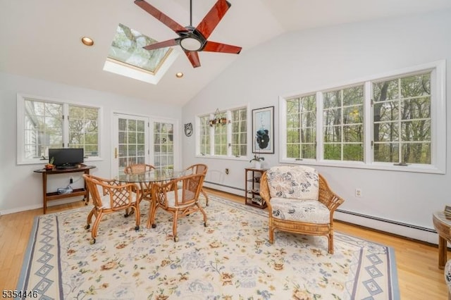 sunroom with a baseboard radiator and a skylight