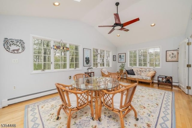 dining room featuring ceiling fan, a baseboard heating unit, lofted ceiling, light wood-style floors, and recessed lighting