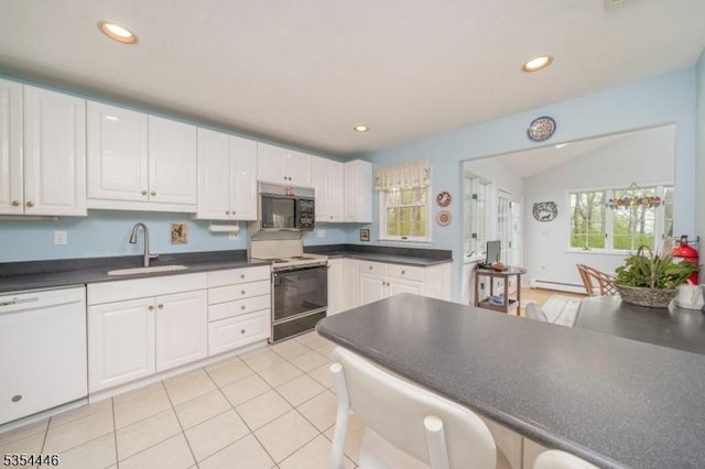 kitchen with white dishwasher, black microwave, electric range oven, baseboard heating, and a sink