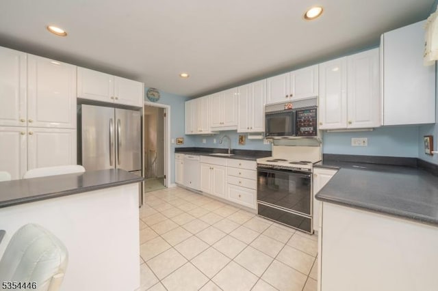 kitchen featuring black microwave, dark countertops, stainless steel fridge, electric stove, and dishwasher