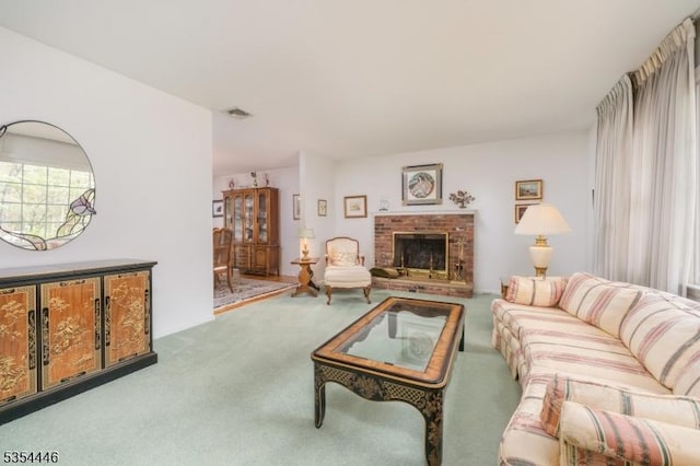 carpeted living area featuring a brick fireplace and visible vents