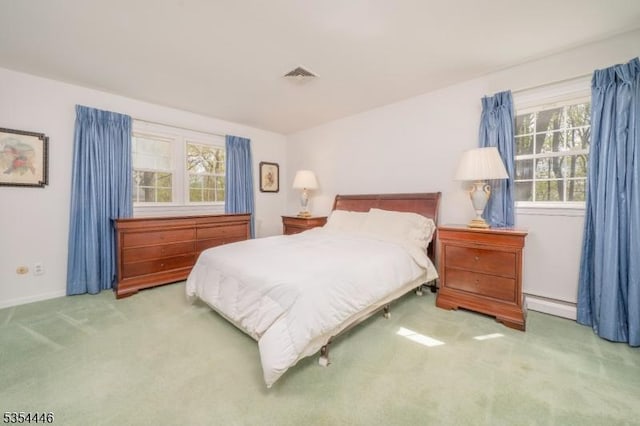 bedroom with baseboards, a baseboard radiator, carpet flooring, and visible vents