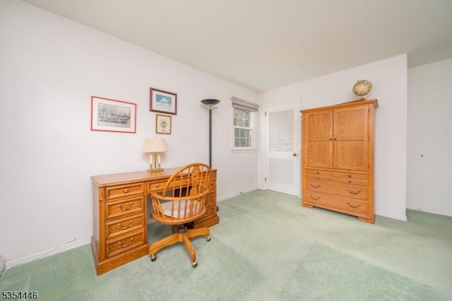 office with baseboards and light carpet