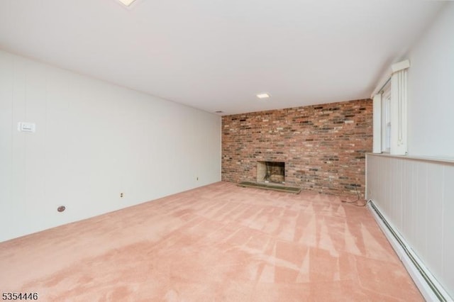 unfurnished living room with a baseboard radiator, light carpet, and a brick fireplace