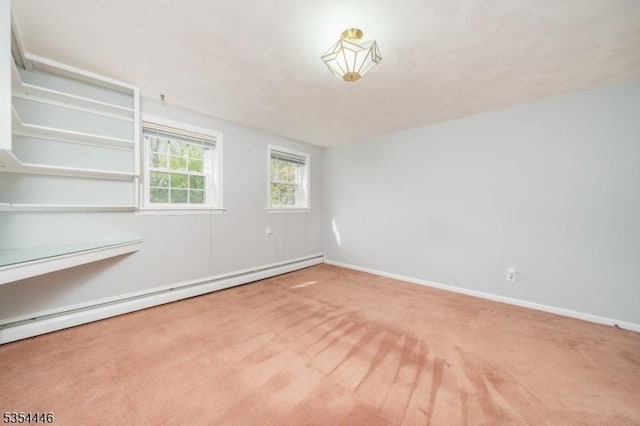 carpeted empty room featuring baseboards and baseboard heating