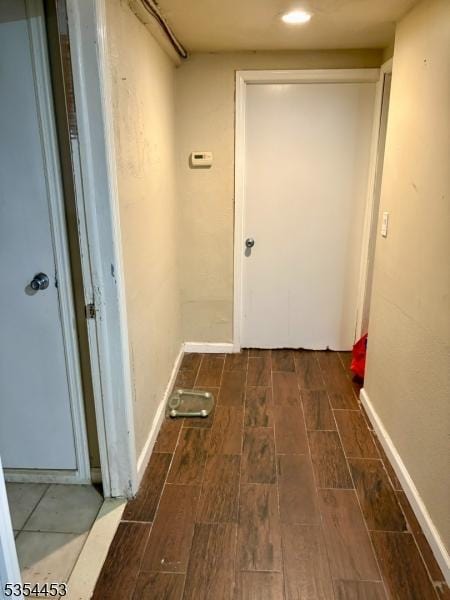 corridor featuring wood tiled floors