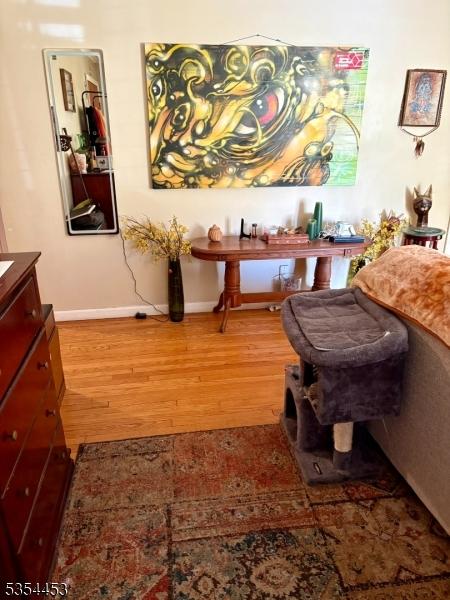 living area with wood finished floors and baseboards