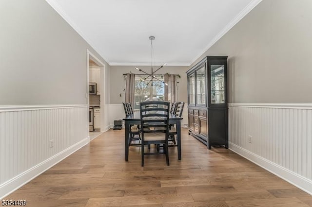 18 Higgins Farm Rd, Delaware Twp, NJ 08559 - dining room featuring an inviting chandelier, ornamental molding, wainscoting, and wood finished floors