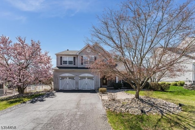 18 Higgins Farm Rd, Delaware Twp, NJ 08559 - view of front of house with an attached garage, fence, and aphalt driveway