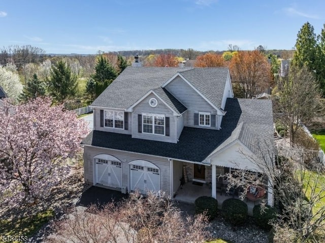 18 Higgins Farm Rd, Delaware Twp, NJ 08559 - view of front of house with a garage, a patio area, driveway, and a shingled roof