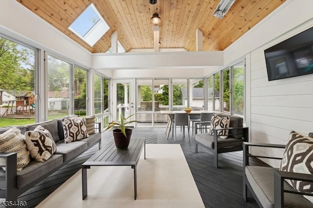 sunroom / solarium with outdoor lounge area, a skylight, healthy amount of natural light, and vaulted ceiling