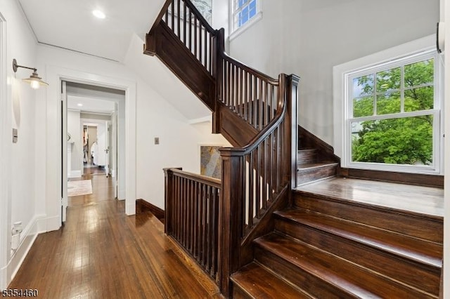 stairs featuring plenty of natural light, baseboards, hardwood / wood-style flooring, and recessed lighting