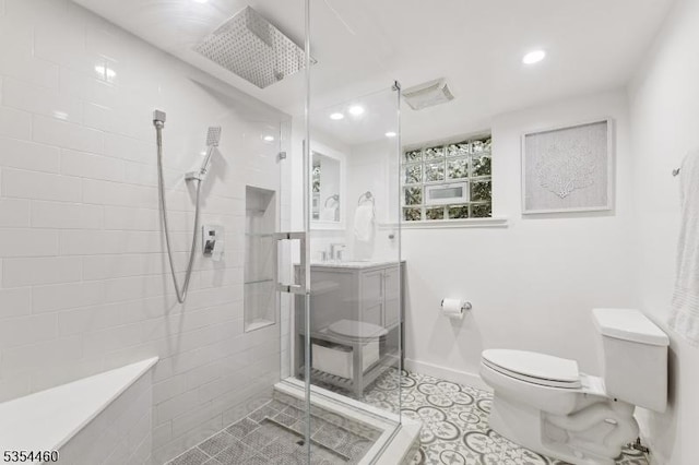 bathroom featuring toilet, a shower stall, baseboards, recessed lighting, and vanity