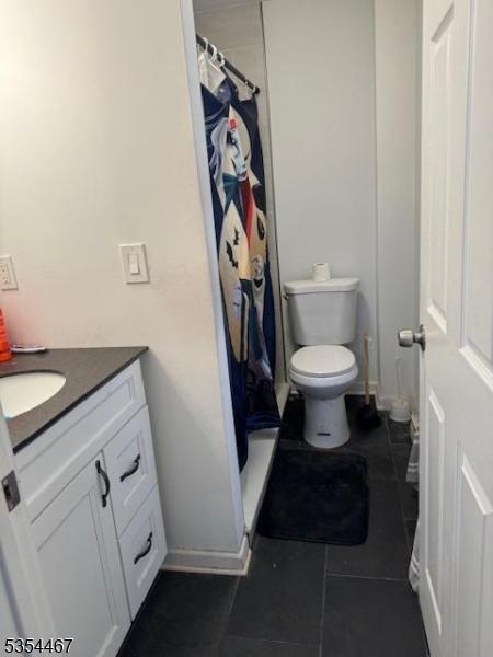 252 Spring St, Newton Town, NJ 07860 - bathroom with tile patterned flooring, vanity, toilet, a shower with shower curtain, and baseboards